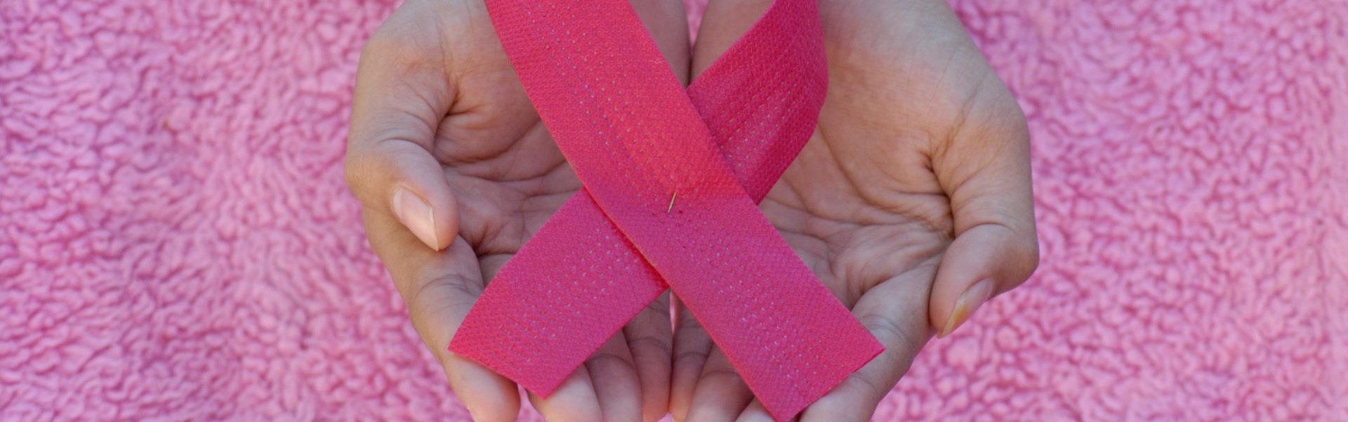 Hand with pink ribbon